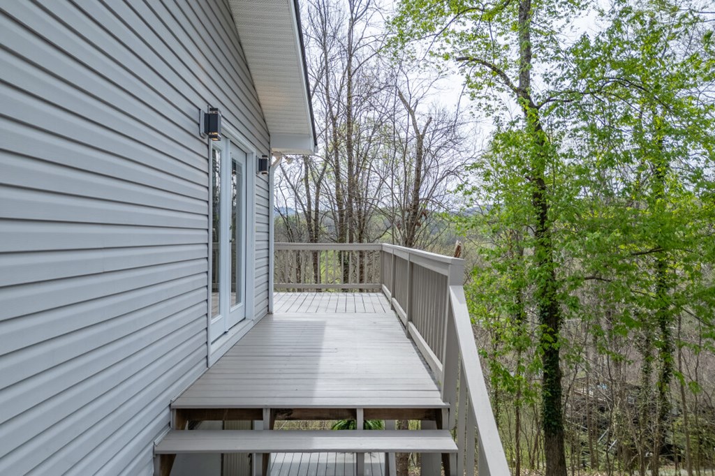 1682 Settlement Road Young Harris, GA 30582 - Photo 37 of 72 a view of a balcony with wooden floor and fence and a pot