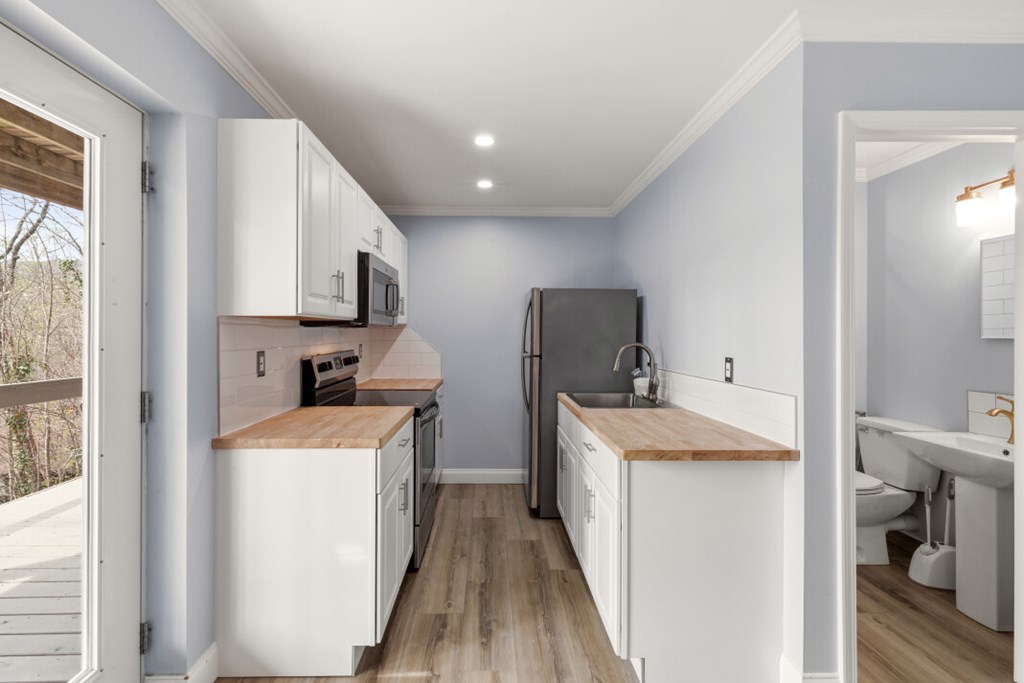 1682 Settlement Road Young Harris, GA 30582 - Photo 48 of 72 a kitchen that has a sink a stove and a refrigerator