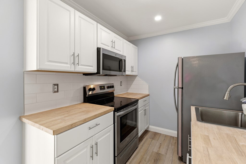 1682 Settlement Road Young Harris, GA 30582 - Photo 51 of 72 a kitchen with stainless steel appliances a stove microwave and refrigerator