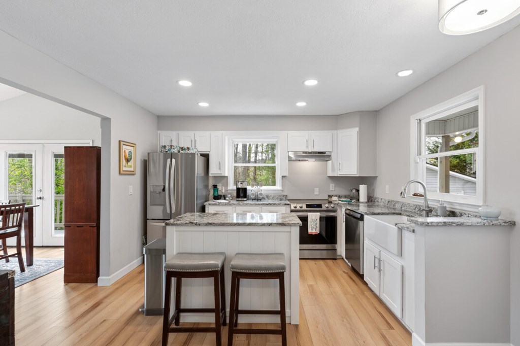 1682 Settlement Road Young Harris, GA 30582 - Photo 9 of 72 a kitchen with stainless steel appliances granite countertop table chairs stove refrigerator and cabinets