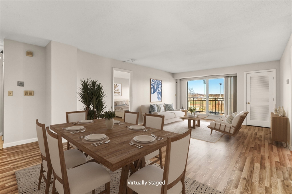 a view of a dining room with furniture and wooden floor