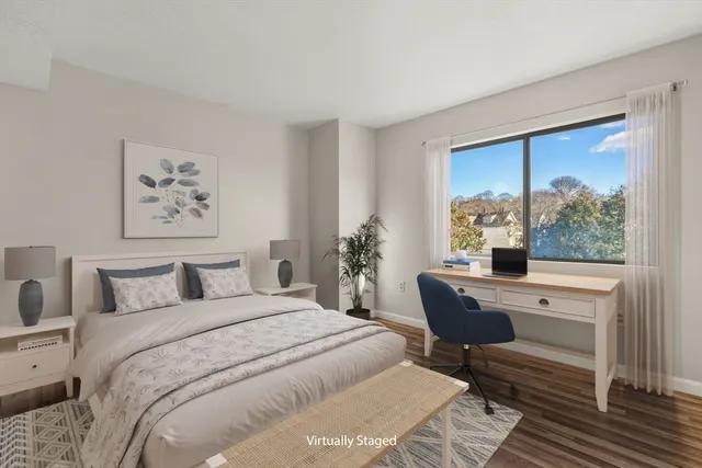 a bedroom with a large bed and a window