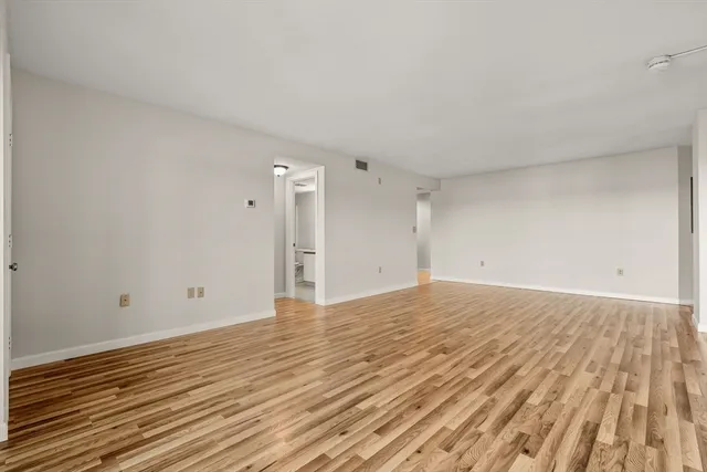 a view of an empty room and wooden floor