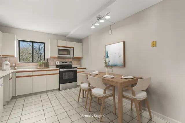 a kitchen with a sink dining table and chairs