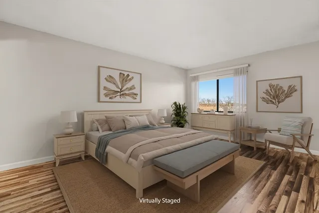 a bedroom with a large bed and paintings on the wall