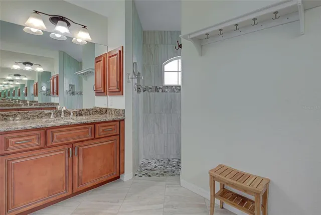 a spacious bathroom with a granite countertop sink a toilet and a mirror