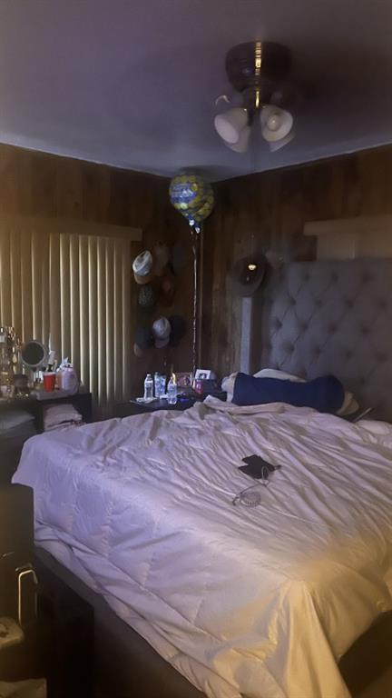 16100 Northwest 28th Court Opa-Locka, FL 33054 - Photo 3 of 4 a bedroom with a bed and a chandelier