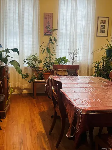 a view of a dining room with furniture and floor to ceiling window