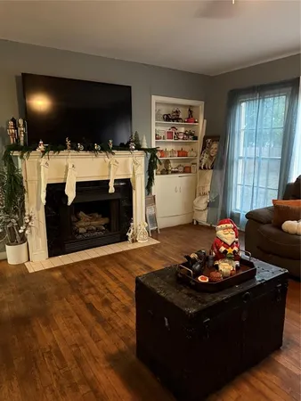 a living room with furniture a flat screen tv and a fireplace
