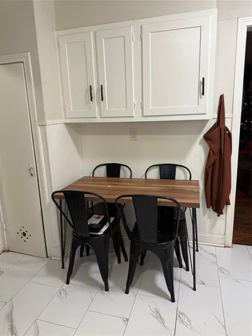 a view of a dining table and chairs in a kitchen
