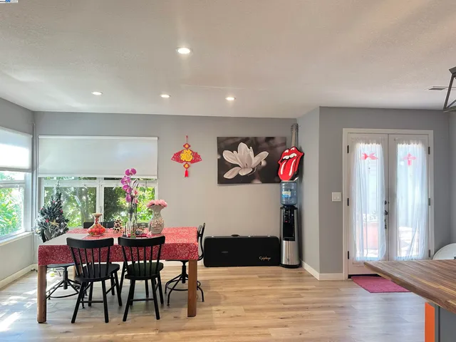 a view of a dining room with furniture and a potted plant