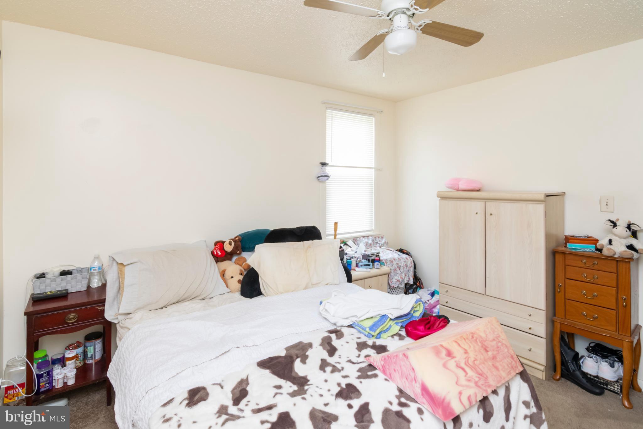 8438 Church Road Pasadena, MD 21122 - Photo 7 of 25 a bed room with a bed and a chandelier
