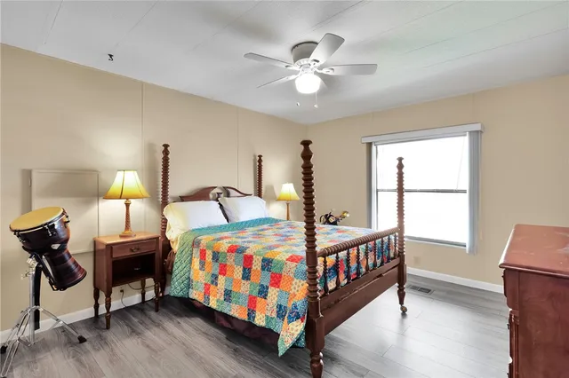 a bedroom with bed and windows