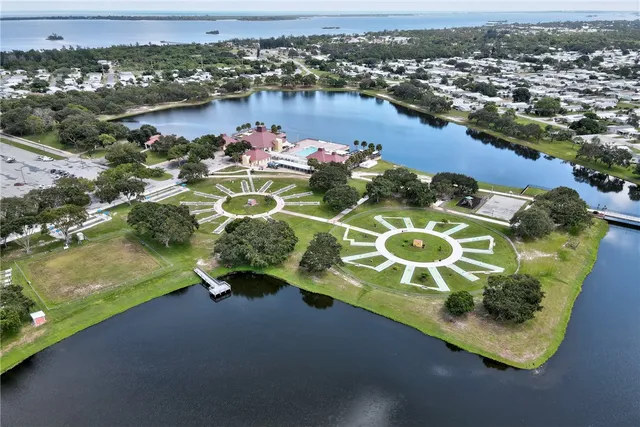 an aerial view of a house with a yard and lake view