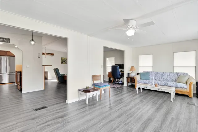 a living room with furniture and a wooden floor