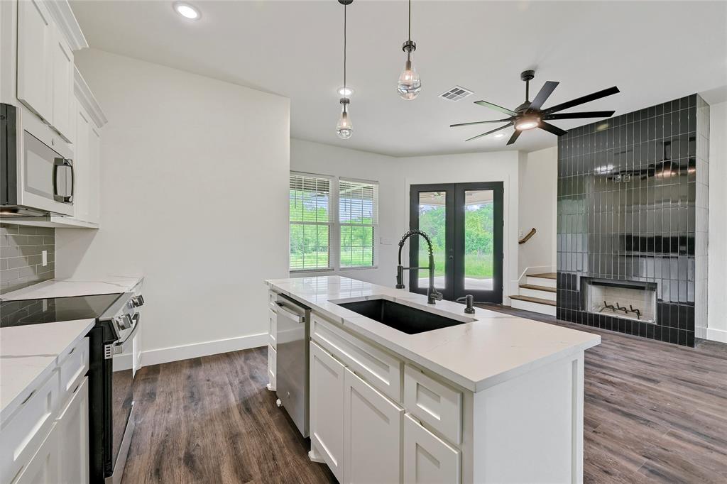 6091 Fm-1753 Denison, TX 75021 - Photo 13 of 40 a kitchen that has a sink a stove and a wooden floor