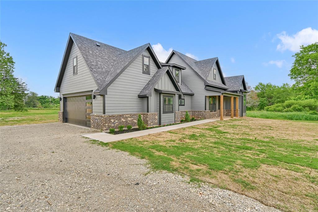 6091 Fm-1753 Denison, TX 75021 - Photo 30 of 40 a front view of a house with a yard and garage