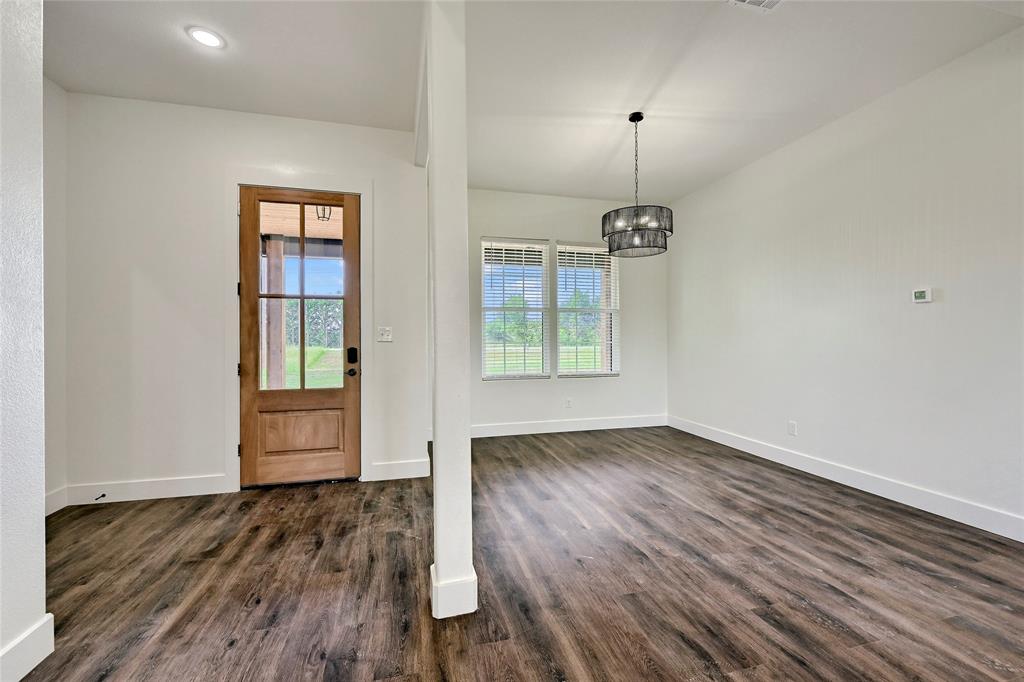 6091 Fm-1753 Denison, TX 75021 - Photo 6 of 40 a view of an empty room with wooden floor and a window