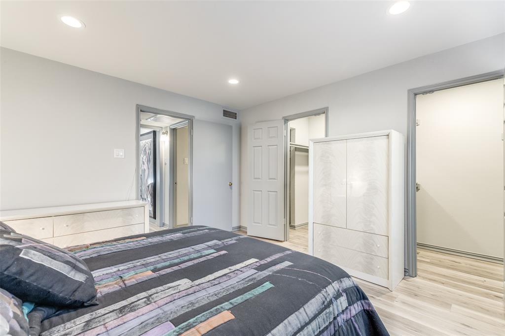 15221 Berry Trail, Unit 405 Dallas, TX 75248 - Photo 12 of 15 a spacious bedroom with a bed and a shower