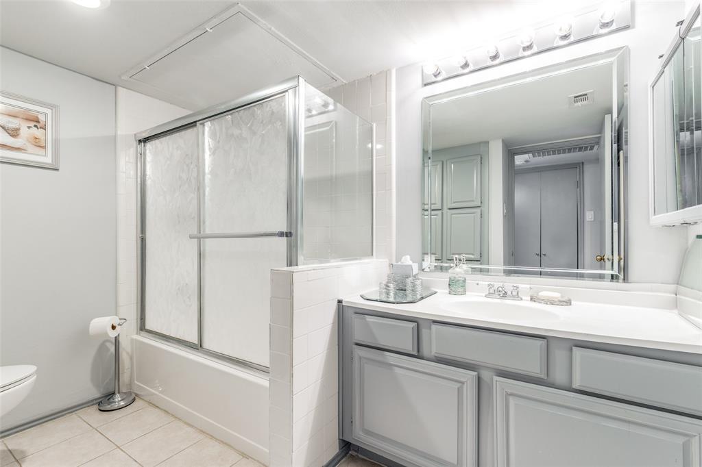 15221 Berry Trail, Unit 405 Dallas, TX 75248 - Photo 13 of 15 a bathroom with a sink and a mirror