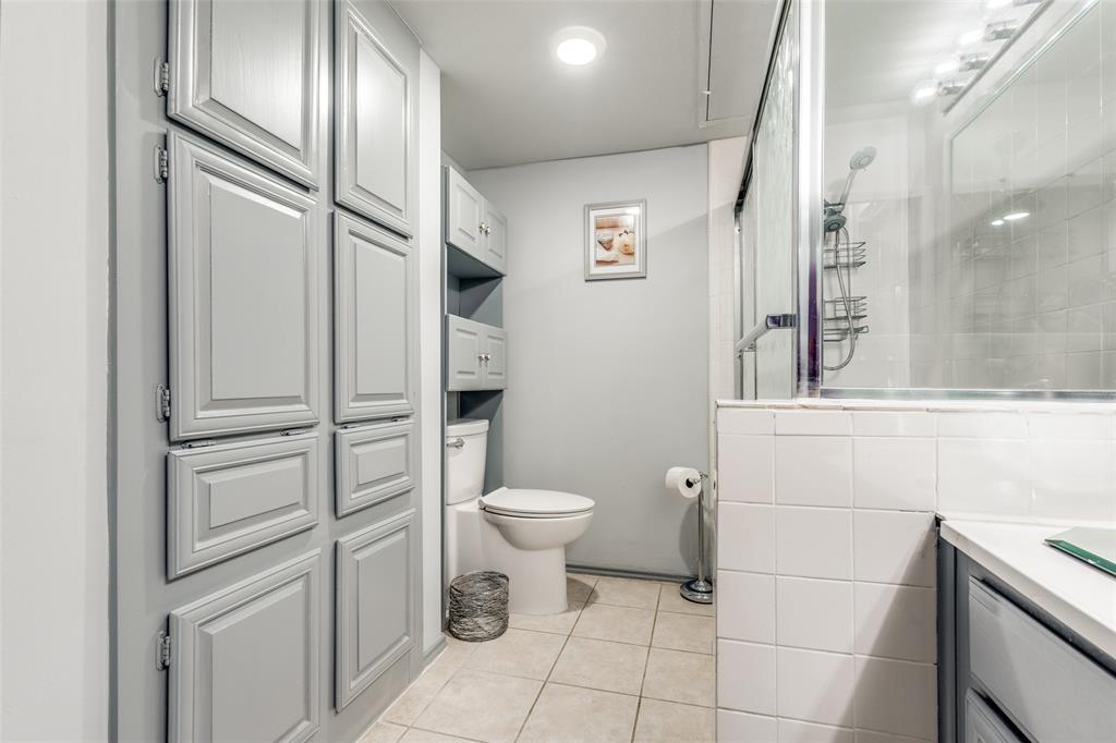 15221 Berry Trail, Unit 405 Dallas, TX 75248 - Photo 14 of 15 a bathroom with a granite countertop toilet and a sink