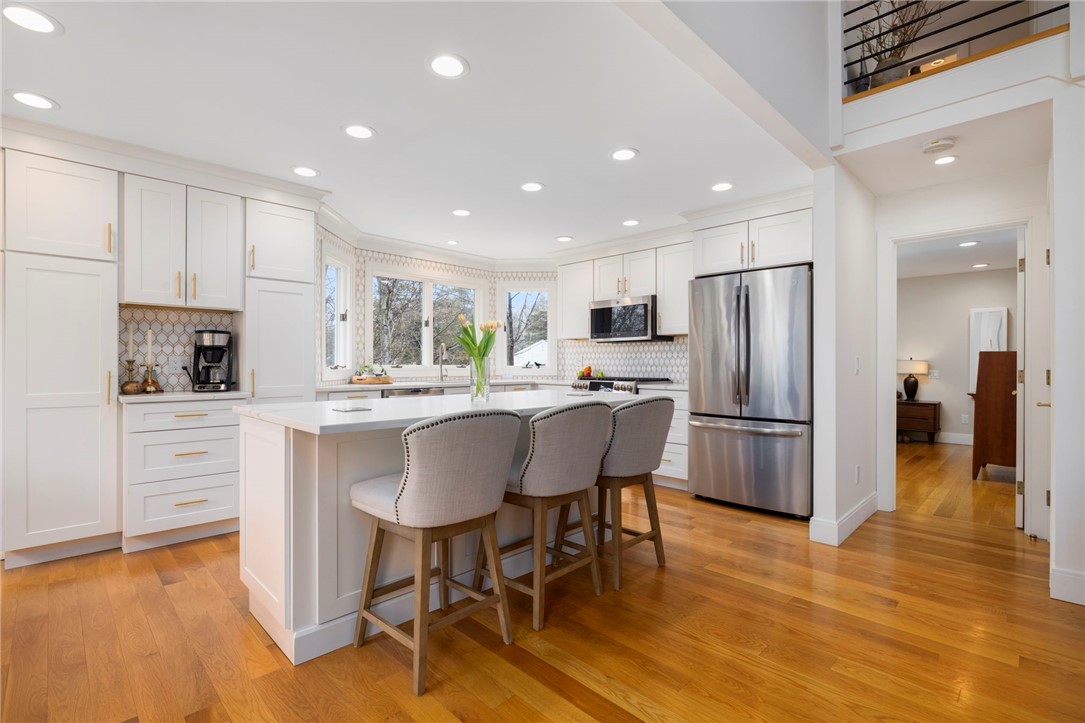 510 Boston Neck Road North Kingstown, RI 02852 - Photo 23 of 43 Down this hall is the main level primary en suite, and the door to the basement.