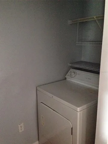 a view of a big room with wooden floor and windows in a room