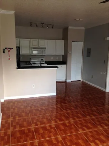 a kitchen with cabinets a sink and stainless steel appliances