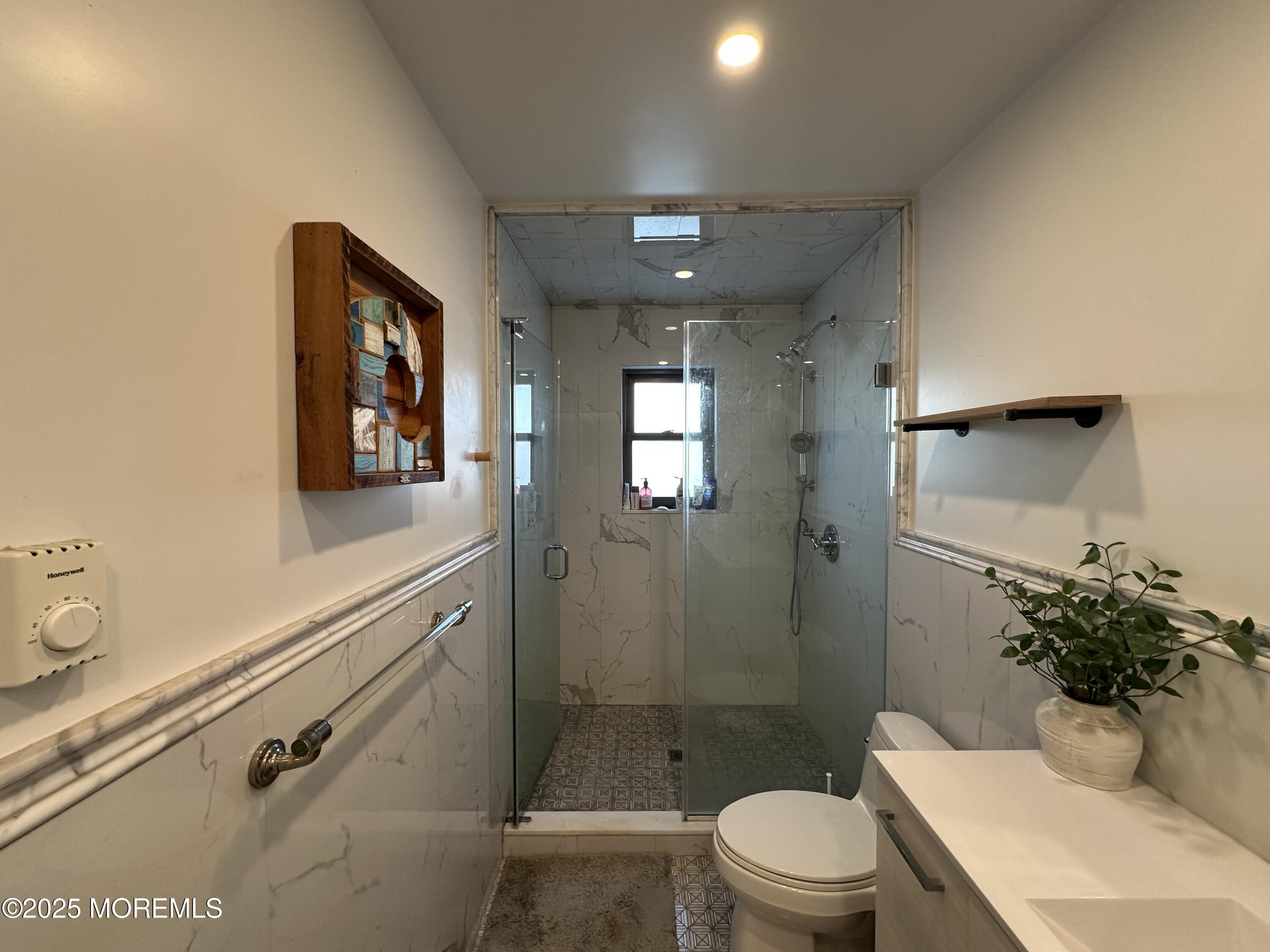 1501 Ocean Avenue, Unit A15 Belmar, NJ 07719 - Photo 11 of 17 a bathroom with a sink a toilet and shower