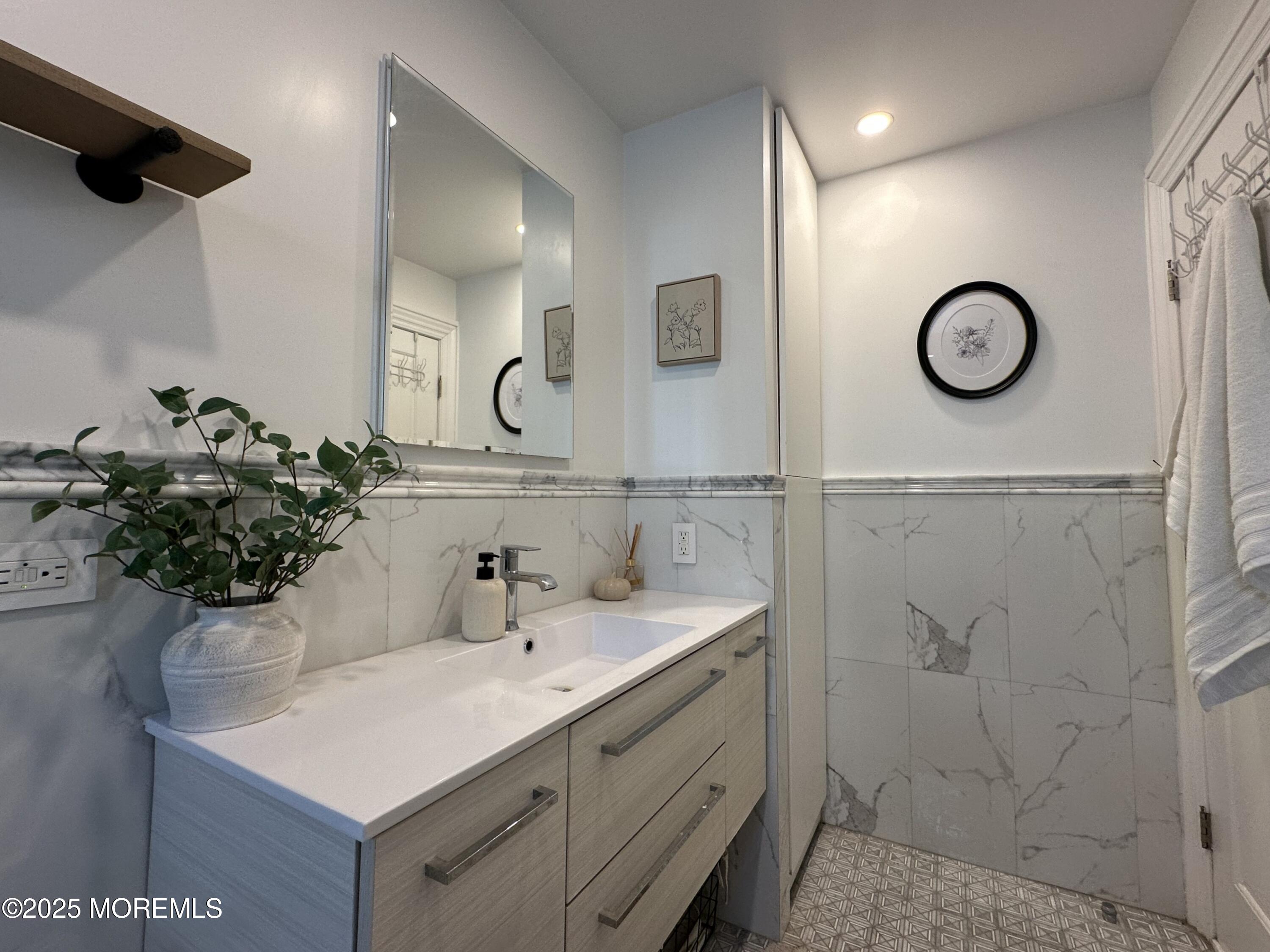 1501 Ocean Avenue, Unit A15 Belmar, NJ 07719 - Photo 12 of 17 a bathroom with a sink and a mirror