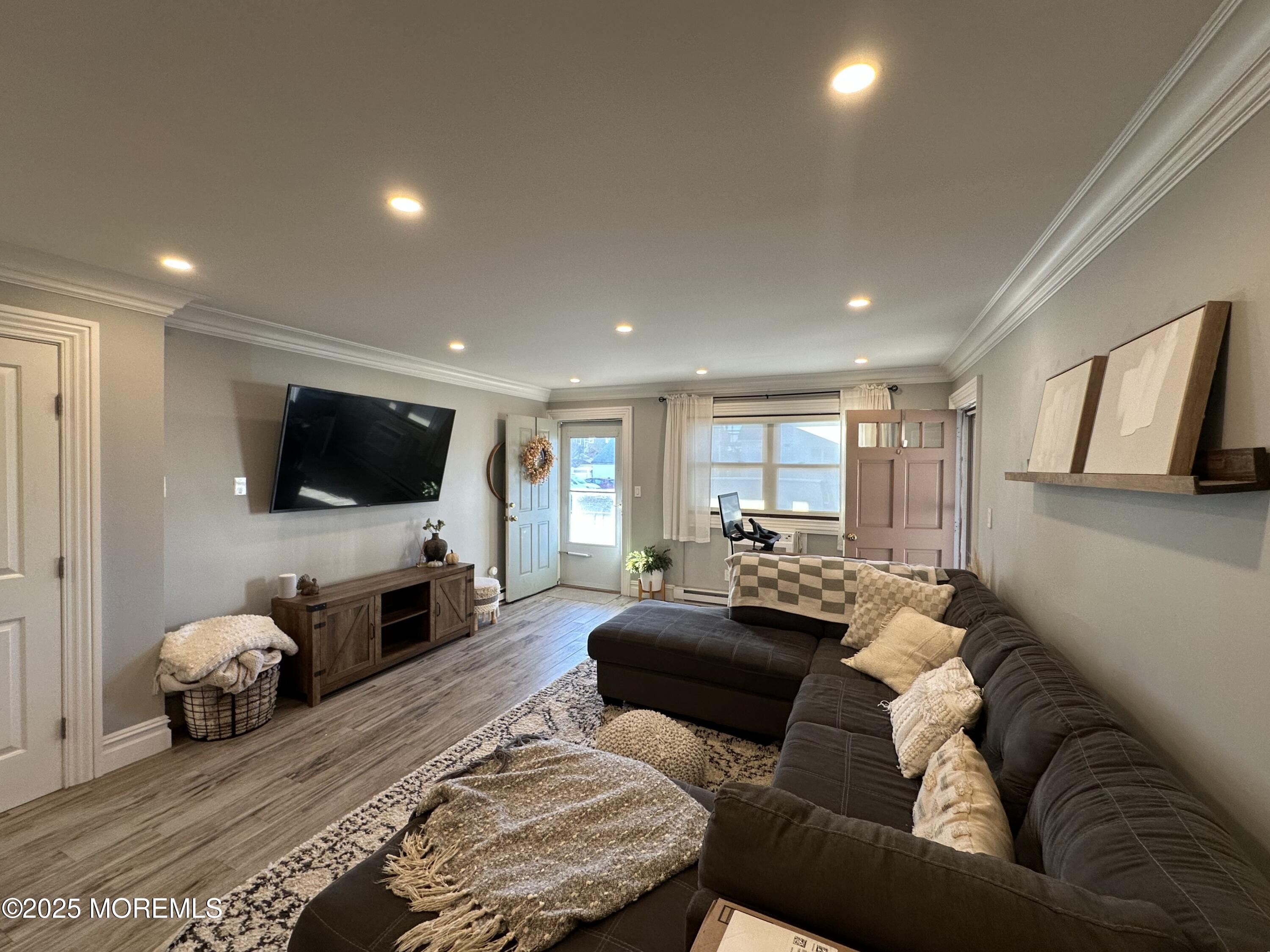 1501 Ocean Avenue, Unit A15 Belmar, NJ 07719 - Photo 2 of 17 a living room with furniture and a flat screen tv