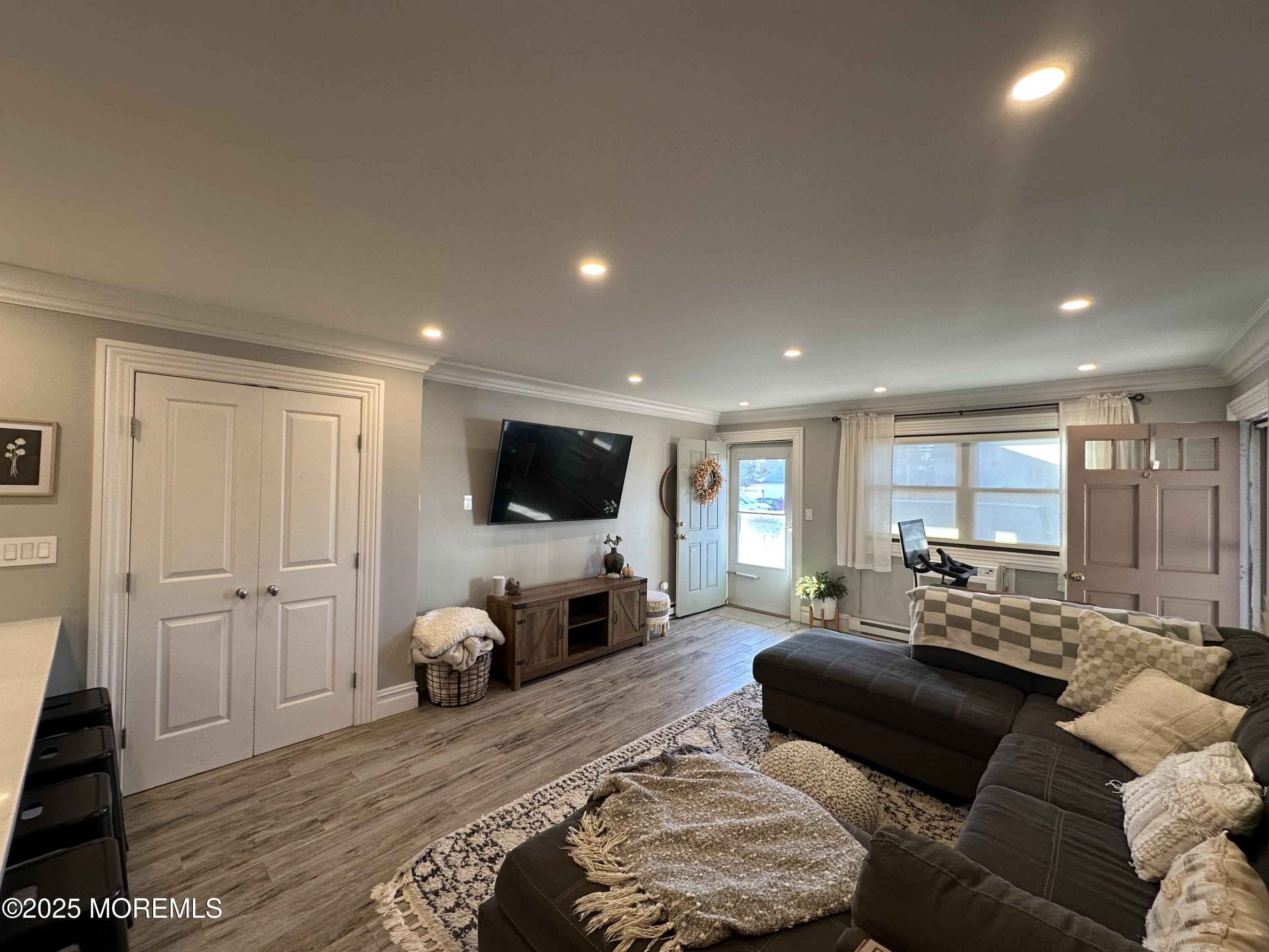 1501 Ocean Avenue, Unit A15 Belmar, NJ 07719 - Photo 3 of 17 a bedroom with furniture and a flat screen tv