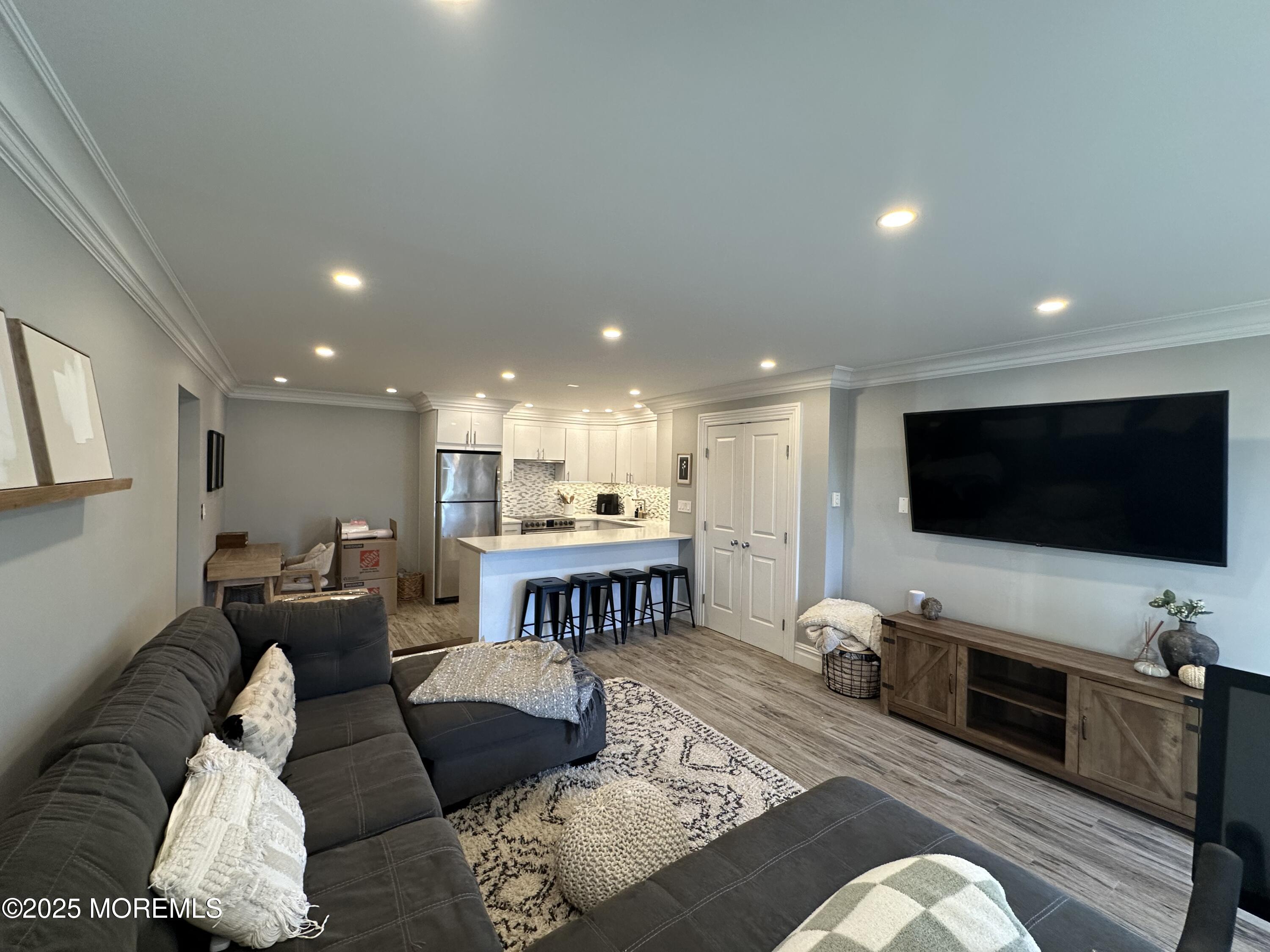 1501 Ocean Avenue, Unit A15 Belmar, NJ 07719 - Photo 4 of 17 a living room with furniture and a flat screen tv