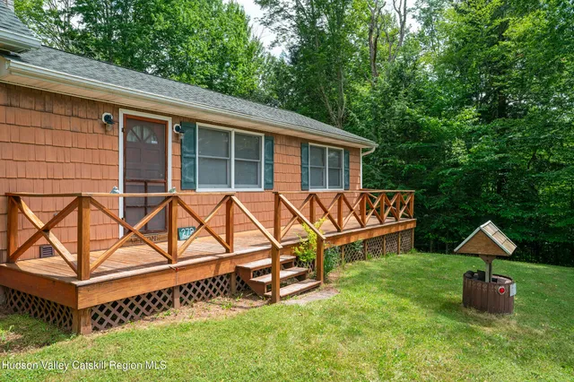 a kitchen with a refrigerator a stove a sink dishwasher a dining table and chairs with wooden floor