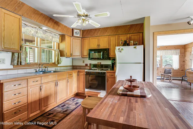 a kitchen that has a table and chairs in it