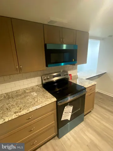 a kitchen with a stove and a microwave