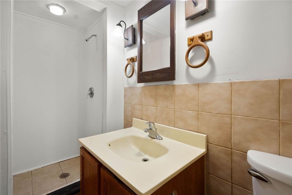 916 2nd Street McKees Rocks, PA 15136 - Photo 19 of 26 a bathroom with a sink a toilet and a mirror