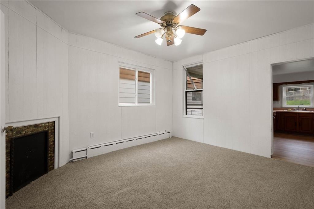 916 2nd Street McKees Rocks, PA 15136 - Photo 5 of 26 an empty room with windows and ceiling fan