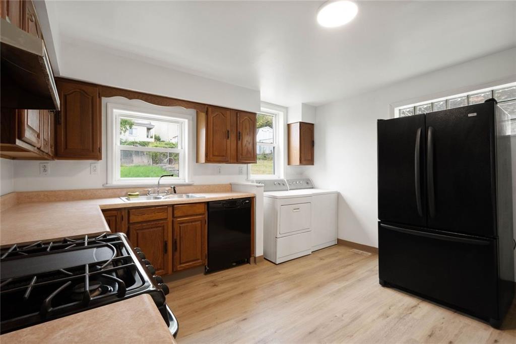 916 2nd Street McKees Rocks, PA 15136 - Photo 8 of 26 a kitchen with a refrigerator stove and sink
