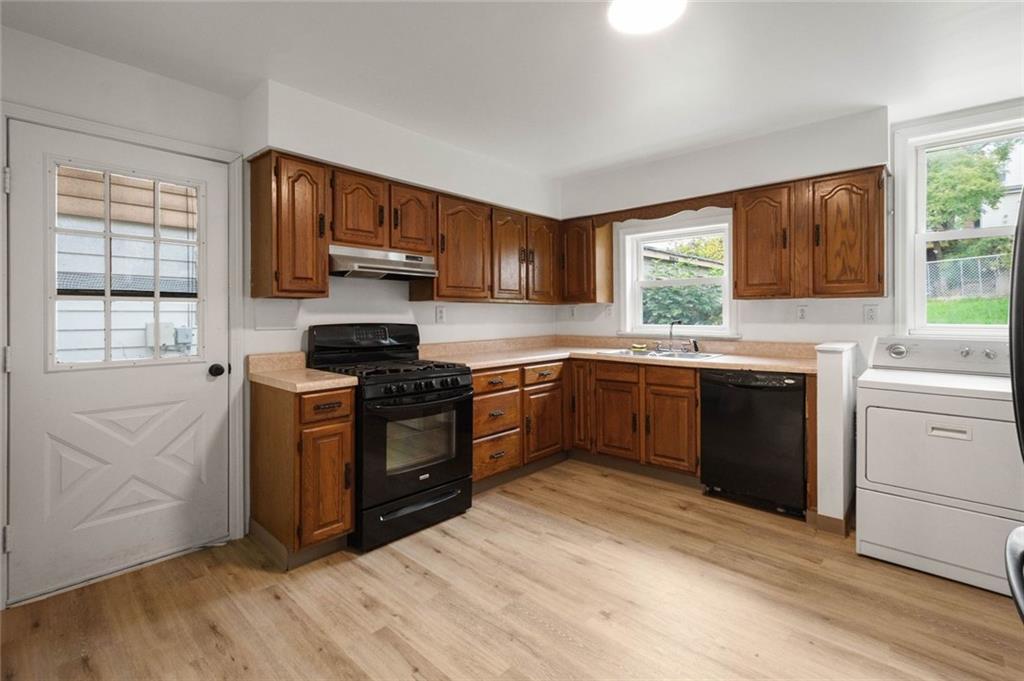 916 2nd Street McKees Rocks, PA 15136 - Photo 10 of 26 a kitchen with a stove a sink and a window