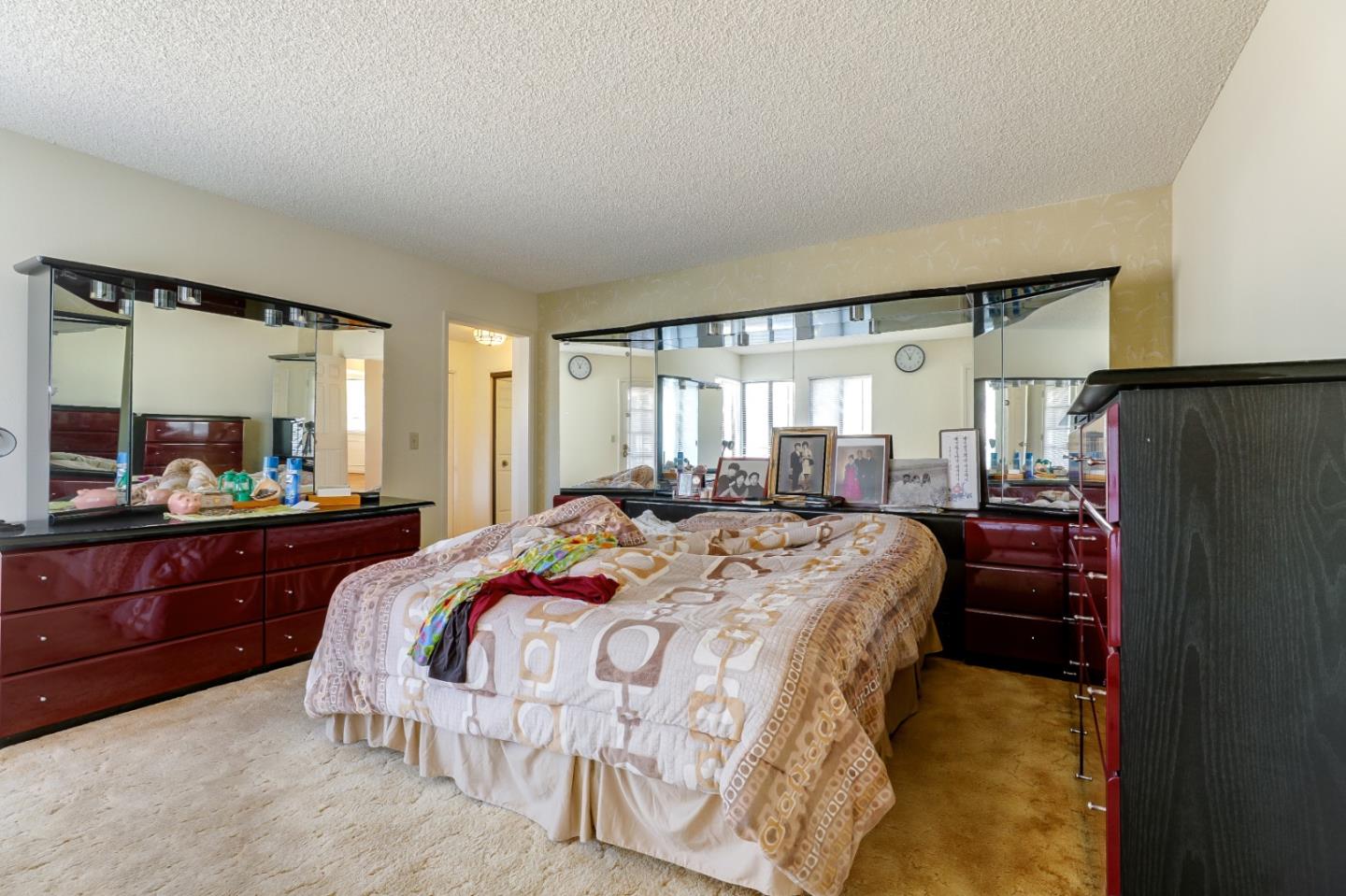 22110 Ranchito Drive Salinas, CA 93908 - Photo 12 of 33 a bedroom with a bed and a mirror on dresser