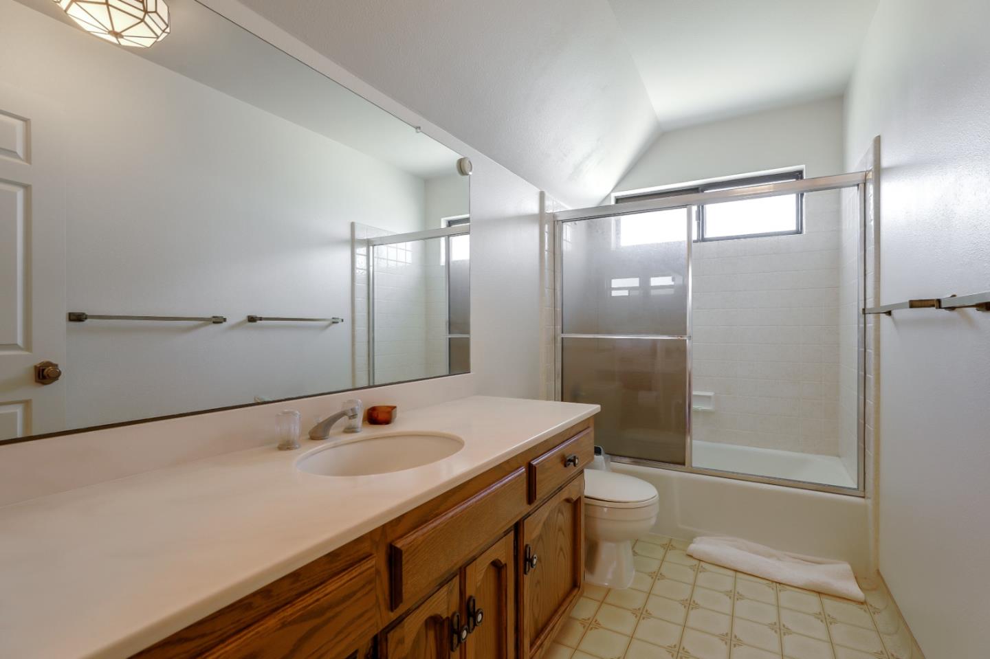 22110 Ranchito Drive Salinas, CA 93908 - Photo 17 of 33 a bathroom with a sink a toilet a mirror and shower
