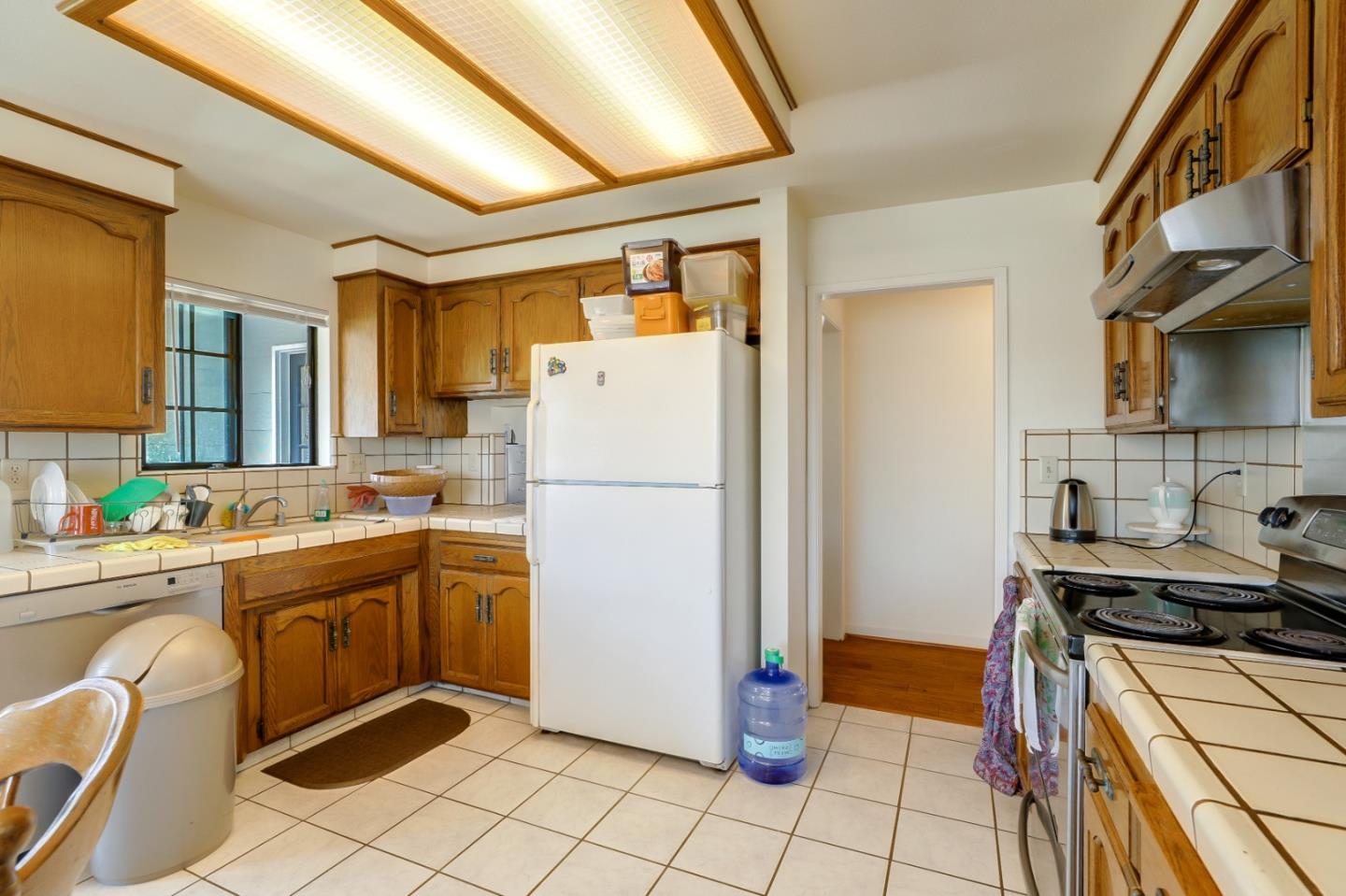 22110 Ranchito Drive Salinas, CA 93908 - Photo 6 of 33 a kitchen with a refrigerator and a stove top oven