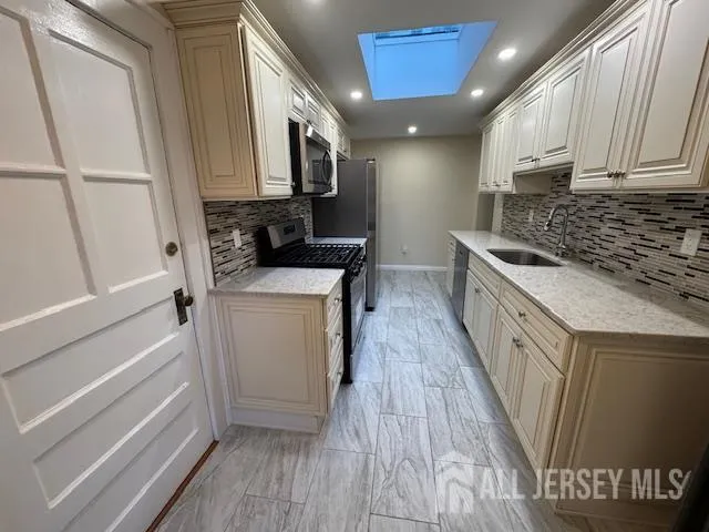 a kitchen with stainless steel appliances granite countertop a stove microwave and refrigerator