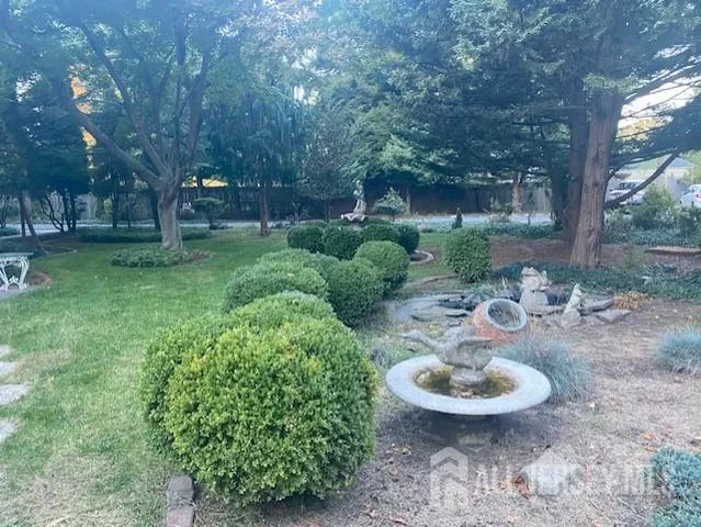 a view of a chair and table in backyard of the house