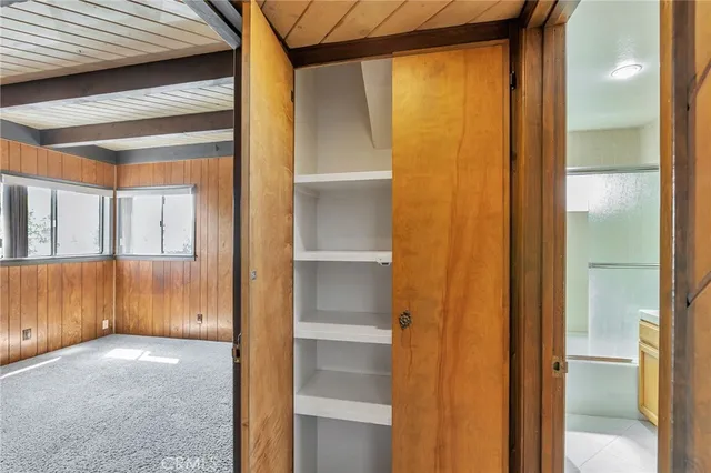 a view of walk in closet with empty room