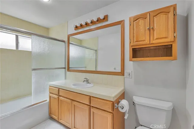 a bathroom with a sink a toilet and vanity