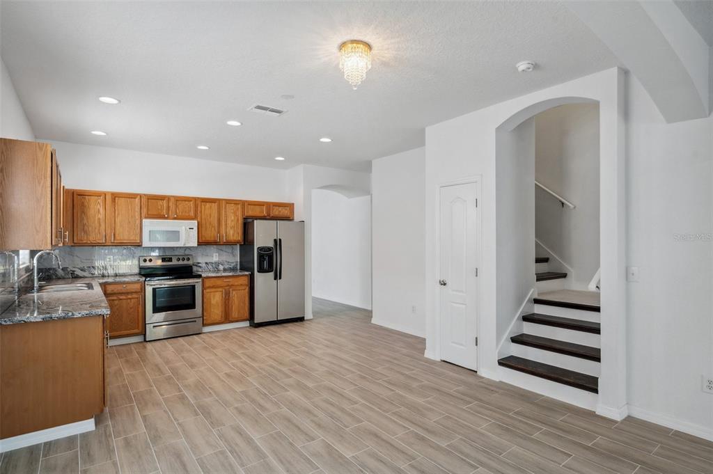 12351 Ridgedale Drive Hudson, FL 34669 - Photo 12 of 54 a kitchen with stainless steel appliances kitchen island granite countertop a stove a sink and a refrigerator