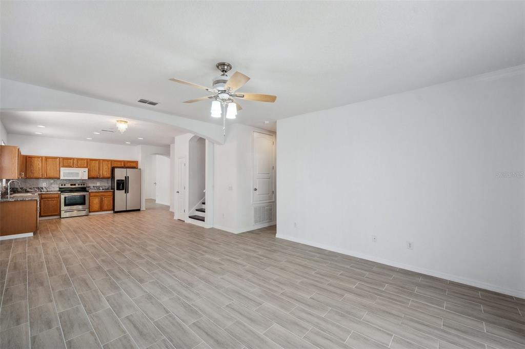 12351 Ridgedale Drive Hudson, FL 34669 - Photo 16 of 54 a view of a livingroom with furniture wooden floor and a ceiling fan