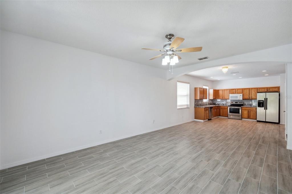 12351 Ridgedale Drive Hudson, FL 34669 - Photo 17 of 54 a view of an empty room with window and wooden floor